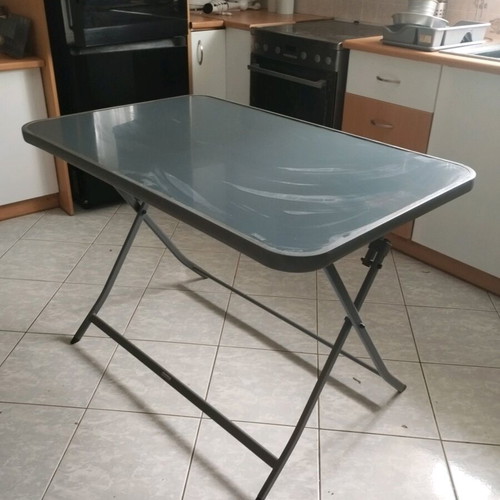 Outdoor table with glass top and metal used