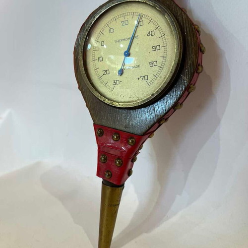 Vintage wall thermometer shaped like a fireplace bellows used