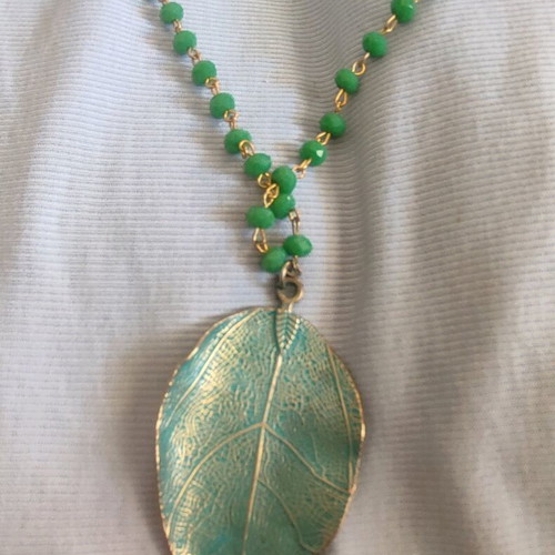 Long necklace new with beads and green leaf motif