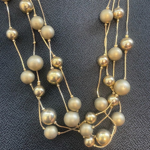 Statement necklace used with shiny and matte gold beads