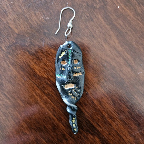 Black earring used, totem-inspired with multicolor pattern