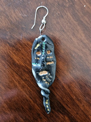 Black earring used, totem-inspired with multicolor pattern