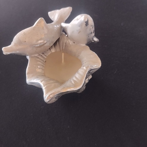 Decorative candle with dolphins used, vintage style
