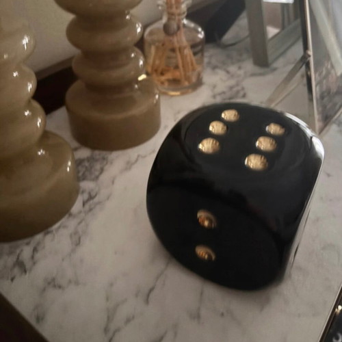 Decorative black dice with gold dots