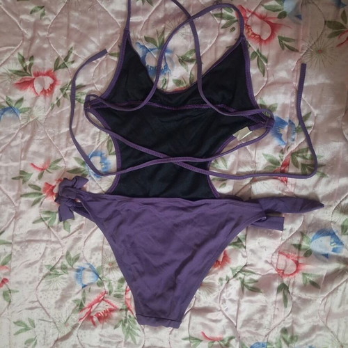 One-piece swimsuit used, purple with cut-outs and adjustable ties, size M