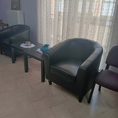 Black leatherette 2-seater sofa, 2 armchairs and 2 IKEA tables