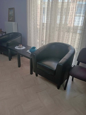 Black leatherette 2-seater sofa, 2 armchairs and 2 IKEA tables