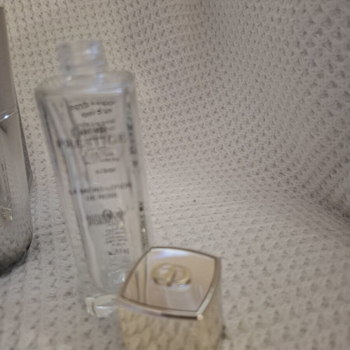 Empty Dior and Estèe Lauder cosmetic jars used, set
