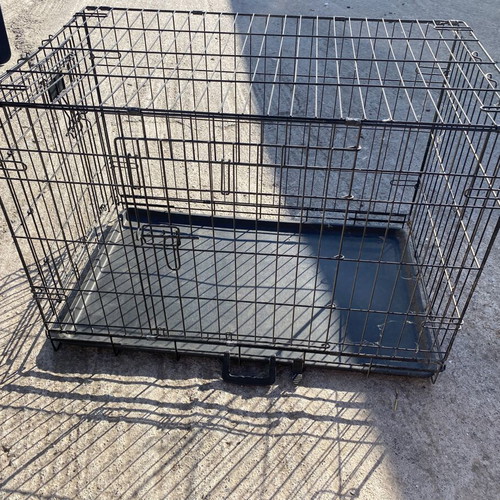 Dog crate used for a large dog with two doors and cleaning tray