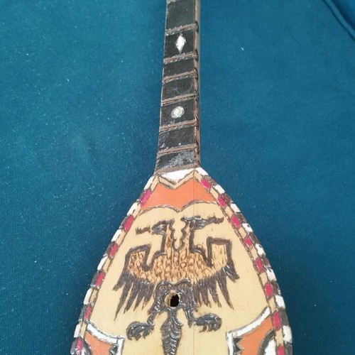Çifteli used Albanian traditional musical instrument with decorative double-headed eagle