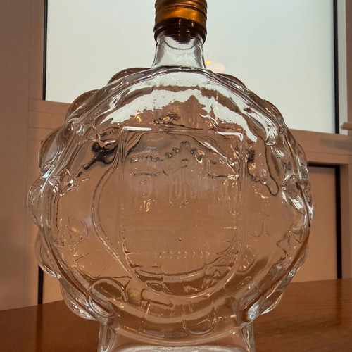 Vintage glass carafe used with embossed castle decorative bottle