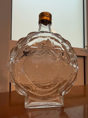 Vintage glass carafe used with embossed castle decorative bottle