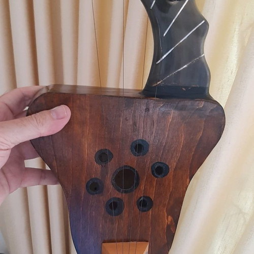 African string instrument used, made of animal horn and wood