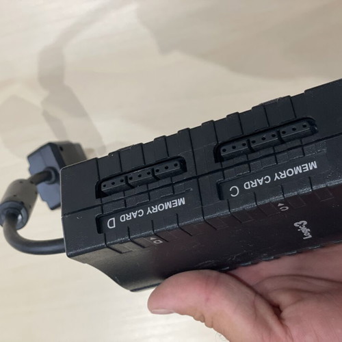 PlayStation 2 console with controller, multi tap and cables