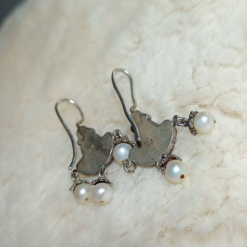 Silver earrings used with purple stones and pearls
