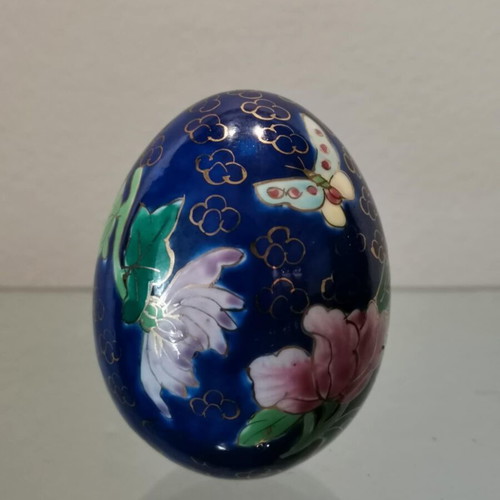 Porcelain egg used with hand-painted flowers and decorative butterflies