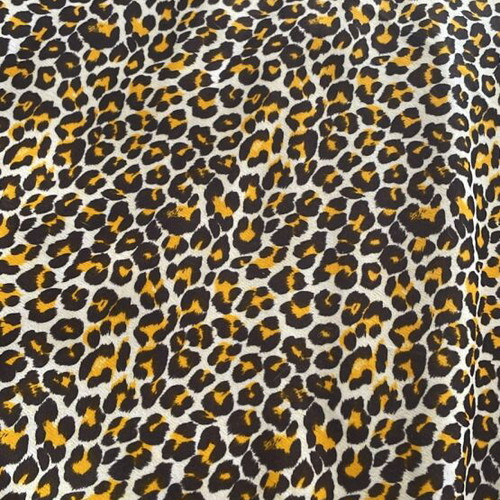 Animal print fabric for upholstery and throws, white with brown and orange