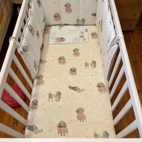 Baby cot like new with unused bedding set and cot bumper