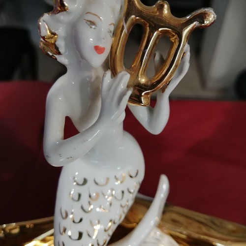 Mermaid and clam used, gold and porcelain decoration