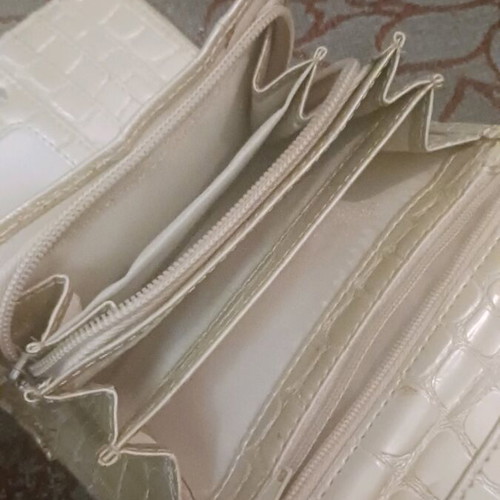 Beige wallet used with card slots and bill compartment