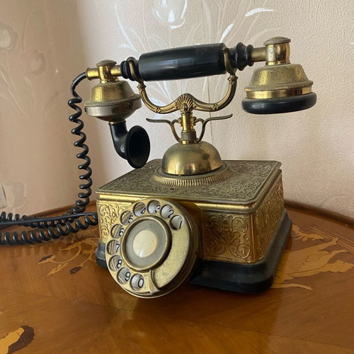 Vintage brass telephone used with embossed designs