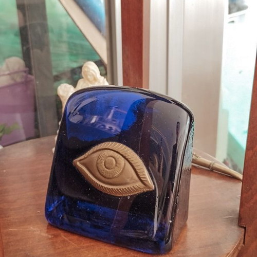 Decorative glass paperweight with metal eye like new