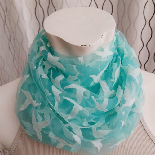Lightweight scarf used, semi-transparent green with white hummingbirds