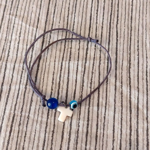 Bracelet with cross charm and evil eye protection