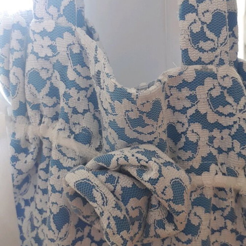 Shoulder bag handmade from white lace with sky blue satin