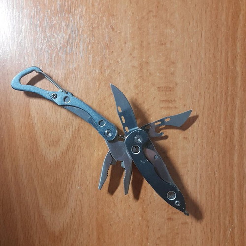 Survival multitool like new with knife, saw, screwdriver and pliers