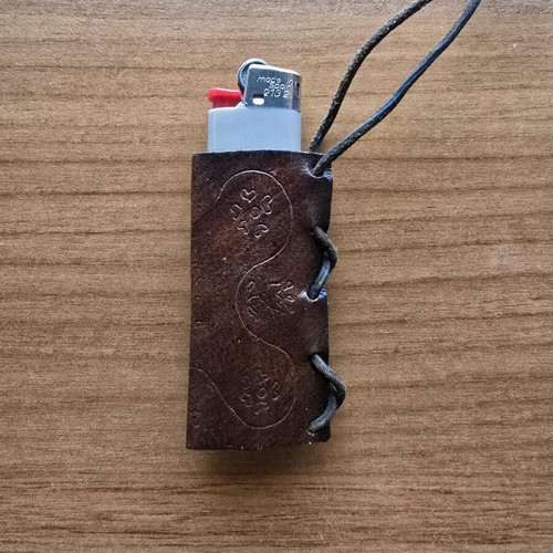 Hanging lighter case like new, carved design