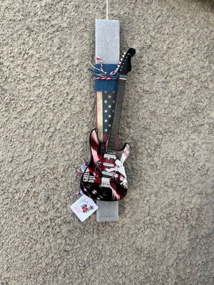 Gray candle with miniature guitar new
