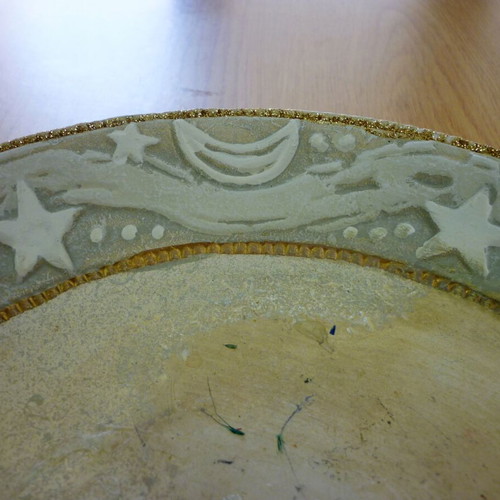 Decorative ceramic plate with embossed stars and moons like new