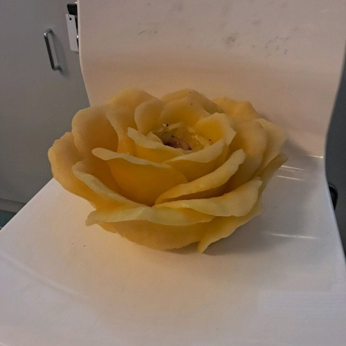 Large decorative rose candle used, yellow