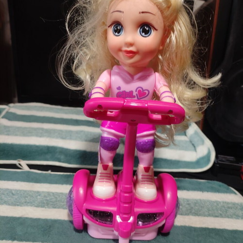 Doll with scooter, sound and lights, like new