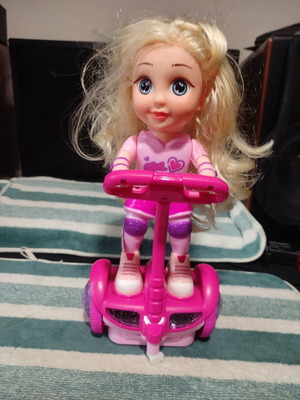 Doll with scooter, sound and lights, like new