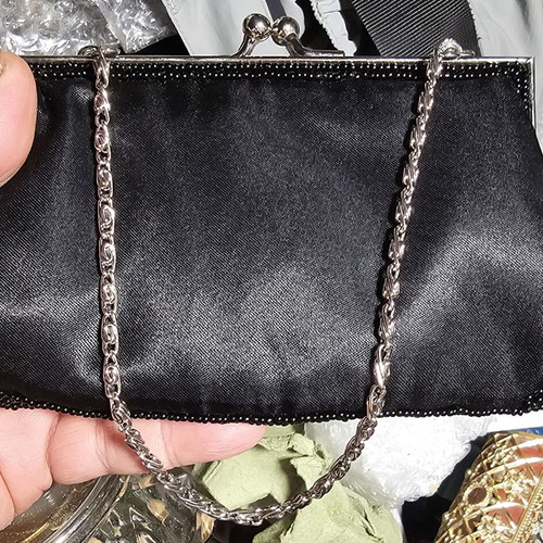 Mad Hat bag used, black handheld