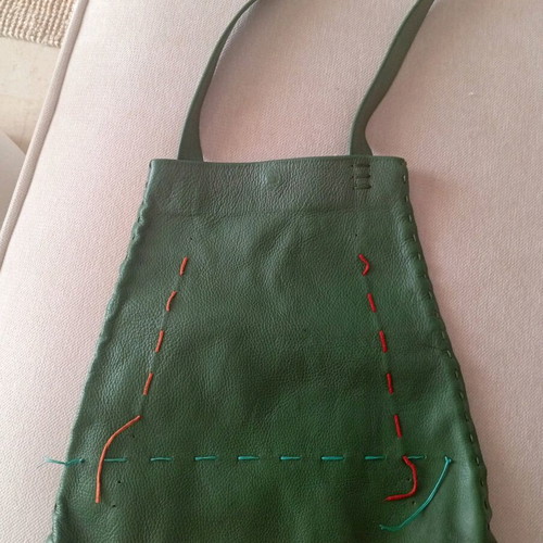 Handmade leather shoulder bag used in deep green boho style