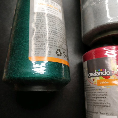 Set of new threads for sewing machine in green, gray and red