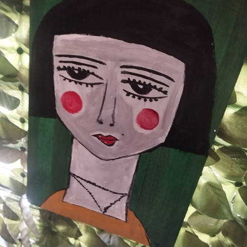 Wood painting of a face