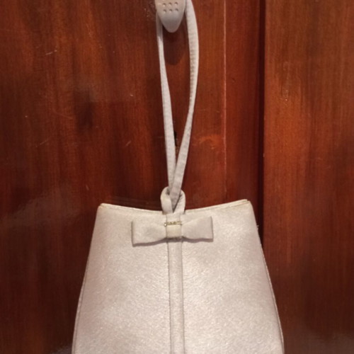 Silver satin evening bag with bow and wrist strap