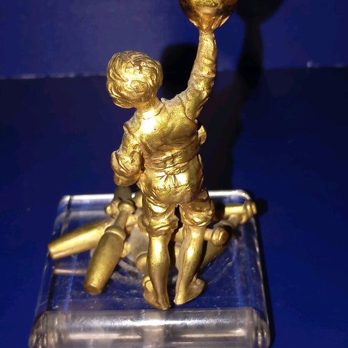 Sculpture of child playing bowling used, bronze with glass base