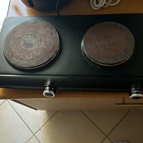 Electric tabletop stove with two burners used