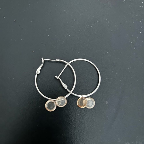 Silver earrings used with gray and orange details