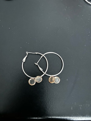 Silver earrings used with gray and orange details