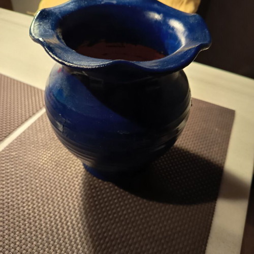 Handmade traditional clay vase with painted flowers