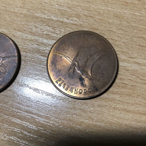 Jurassic World Tetley Velociraptor and Pteranodon coins, 38mm