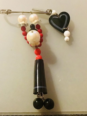 Moschino pin with hanging figure, like new