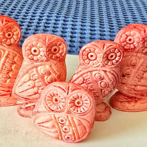 Set of five salmon pink owl figurines