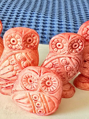 Set of five salmon pink owl figurines